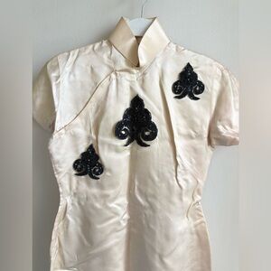 Elegant Cream Cheongsam with Black Embellishments